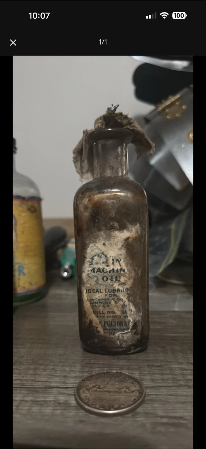 Old machine oil bottle with partial label