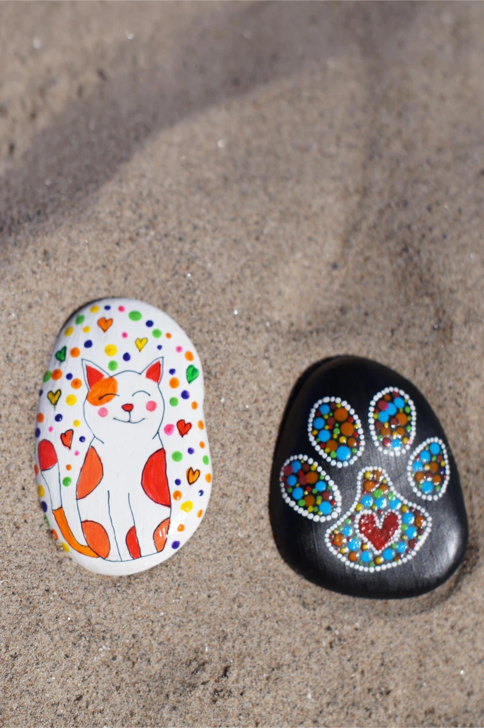Hand-painted decorative stones (cat and paw print)