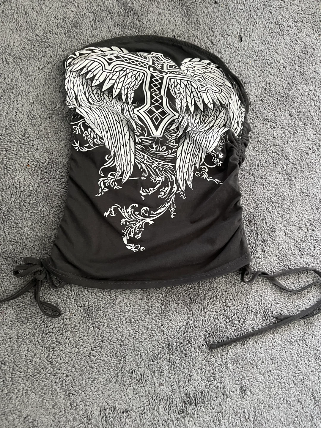 Black graphic tube top with winged cross design