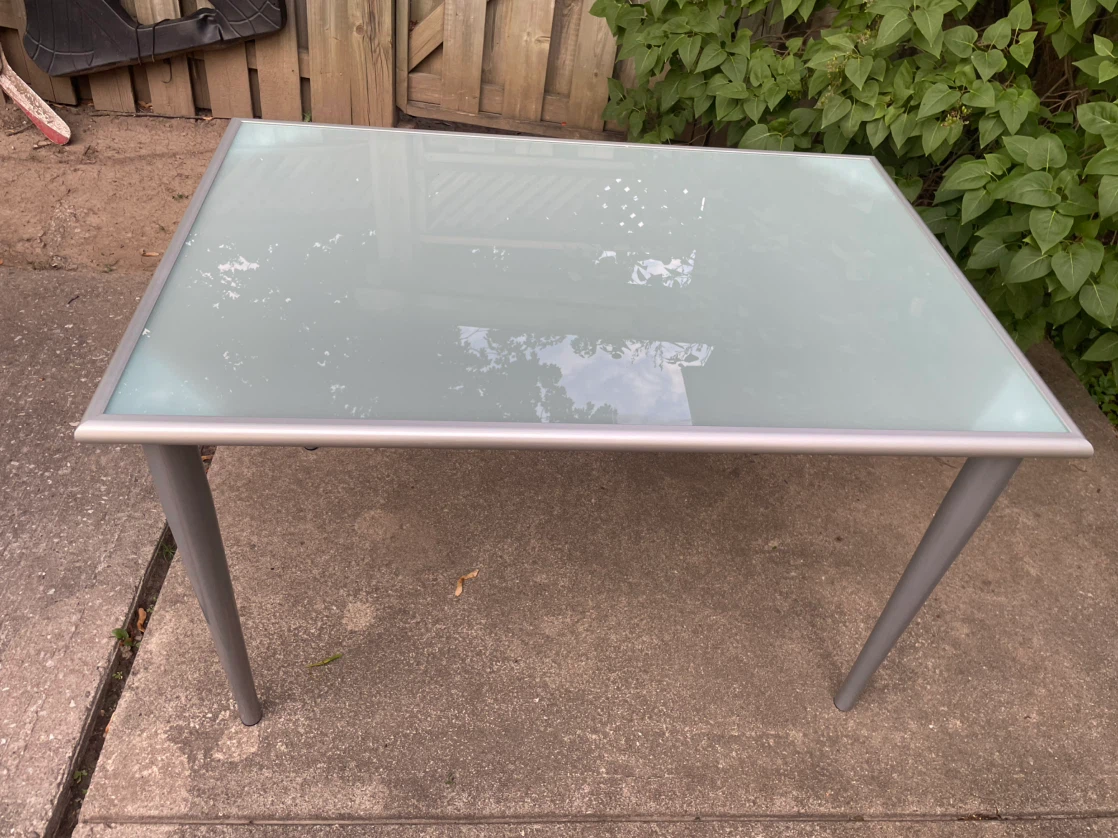 Glass top dining table with metal legs