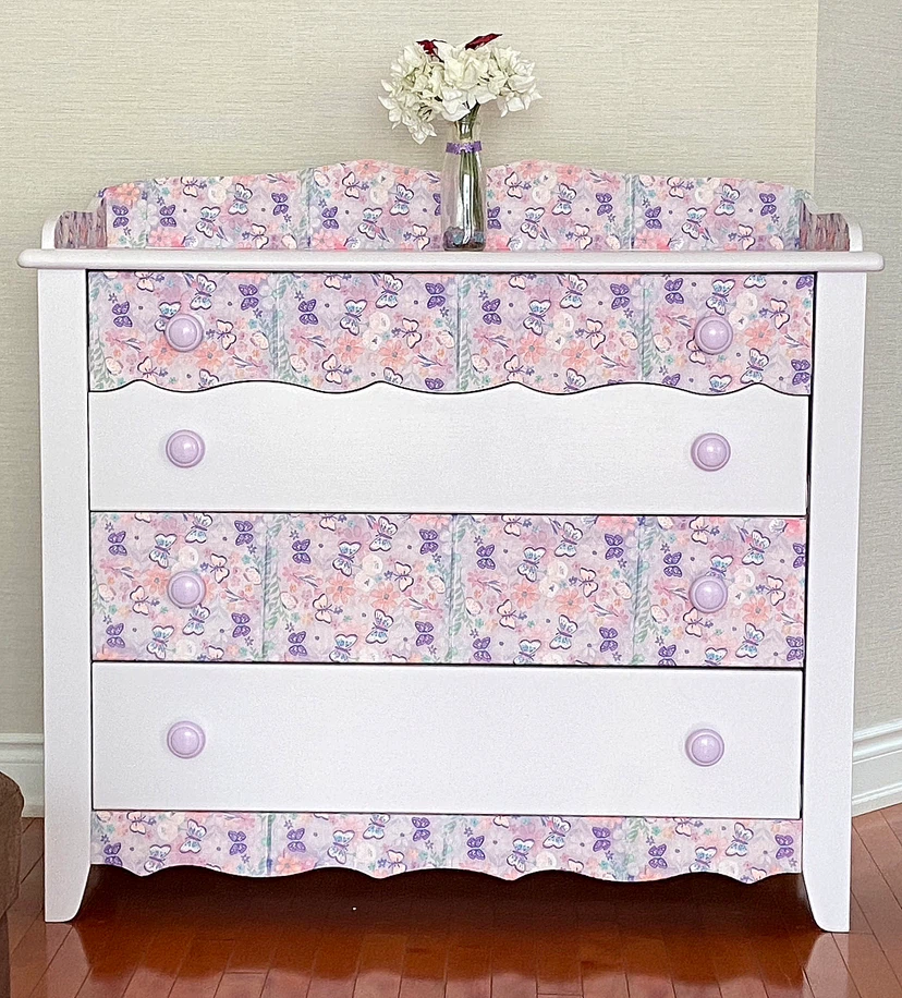 White dresser with purple butterfly and floral print accents