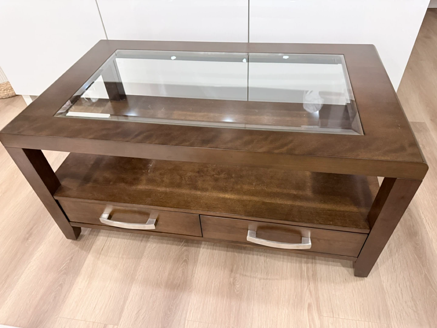 Brown coffee table with glass top and drawers