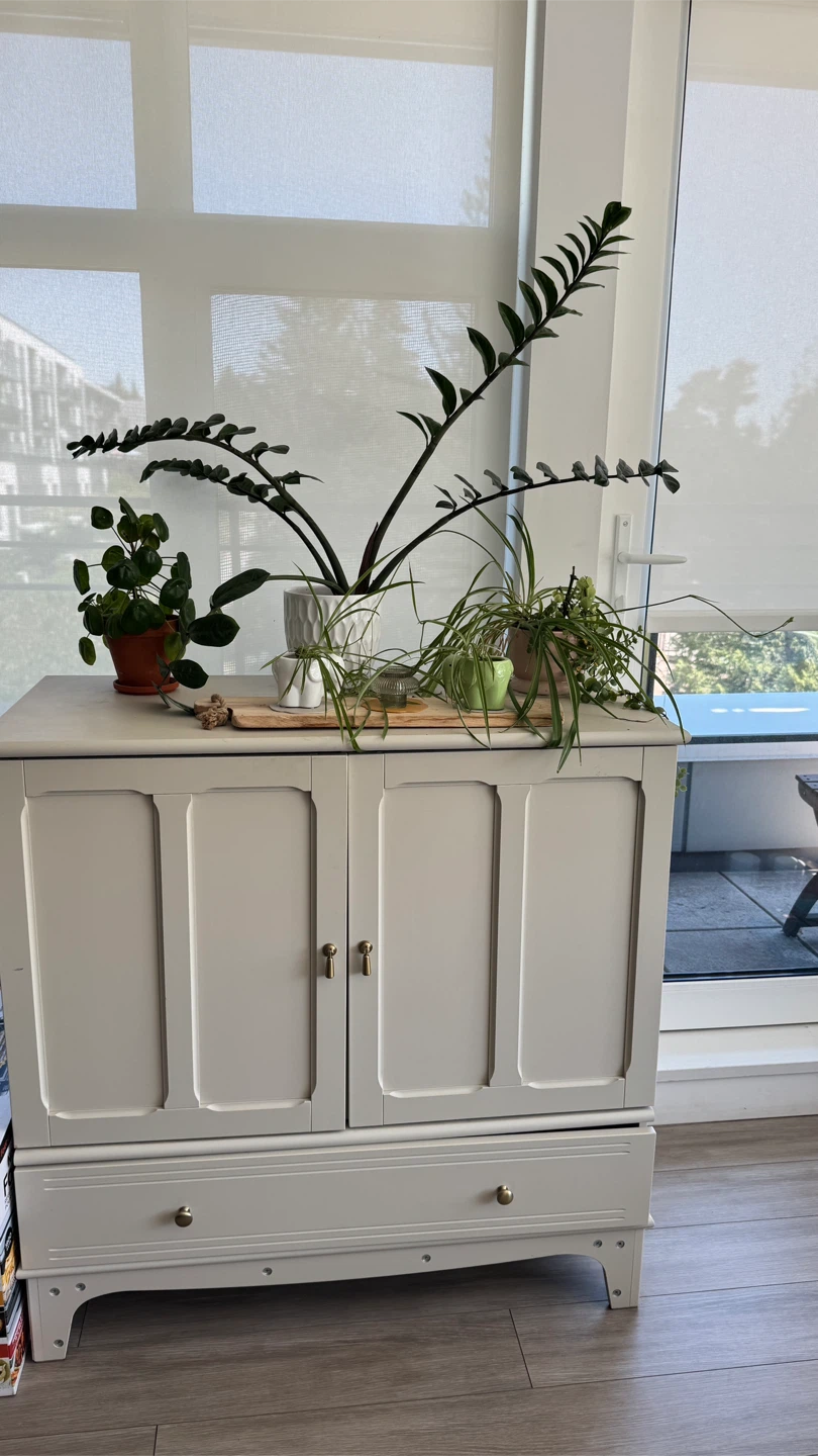 Grey two-door cabinet with drawer