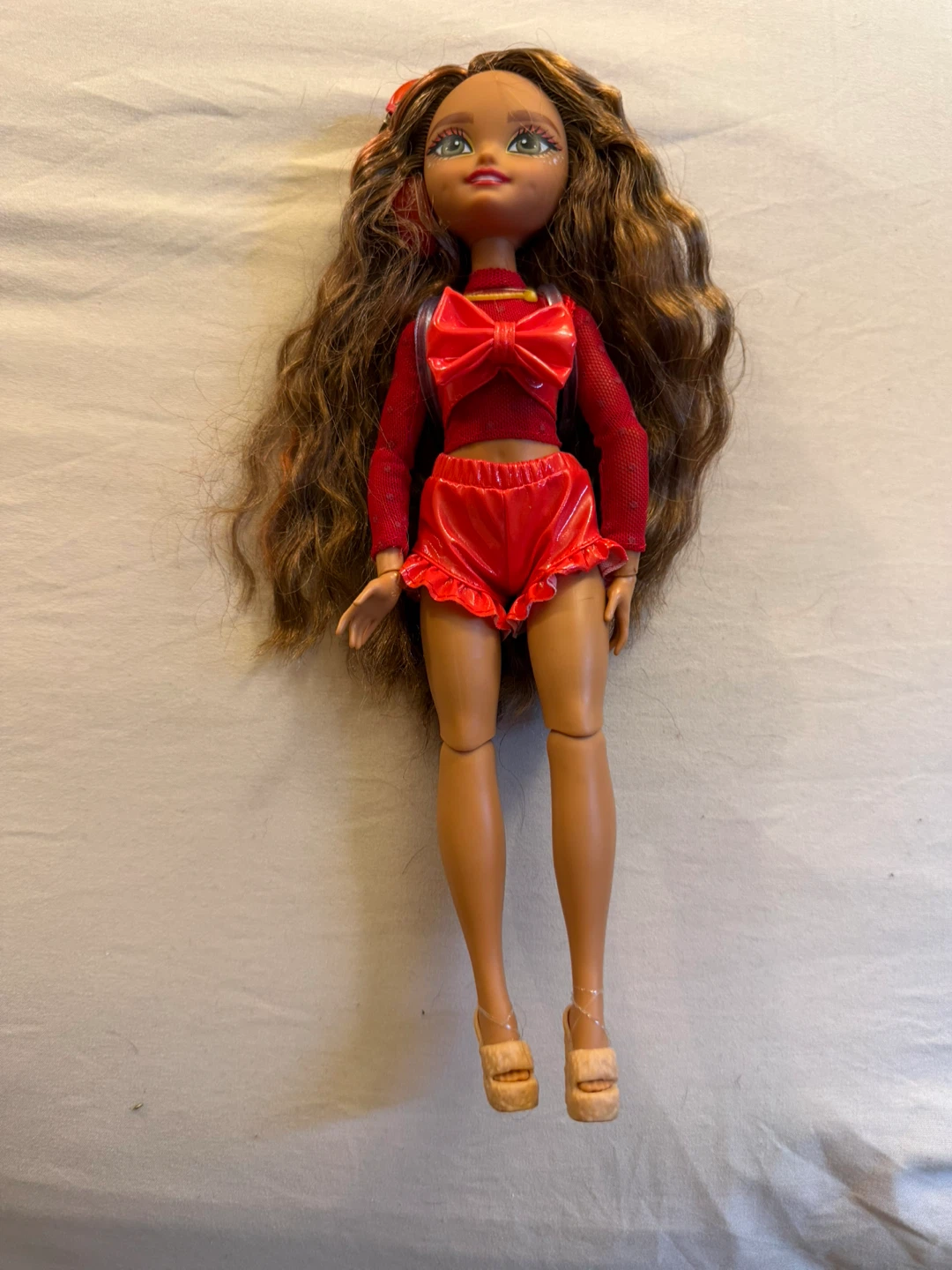 Red doll with wavy brown hair