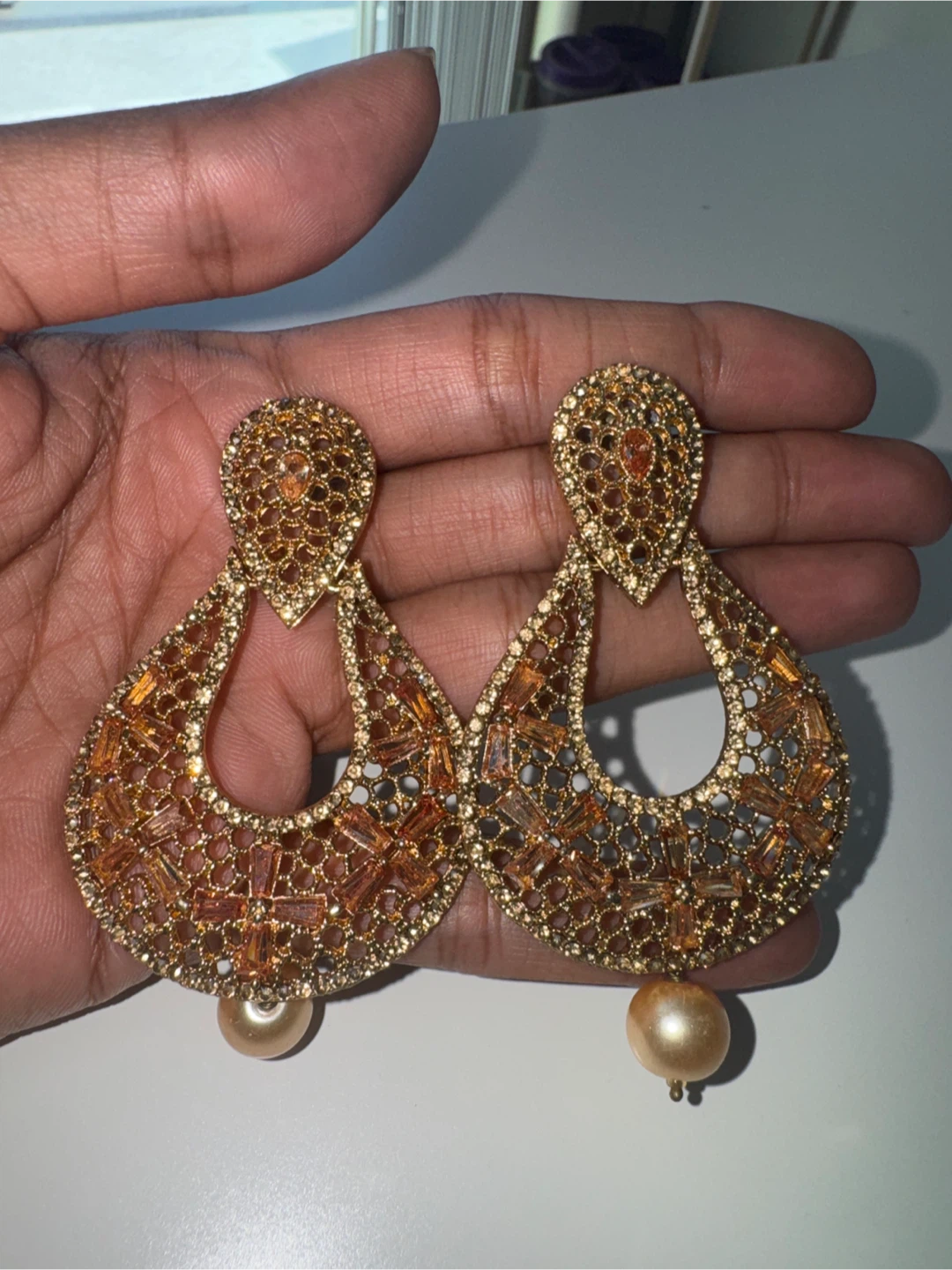Gold tone statement chandelier earrings with pearl drops