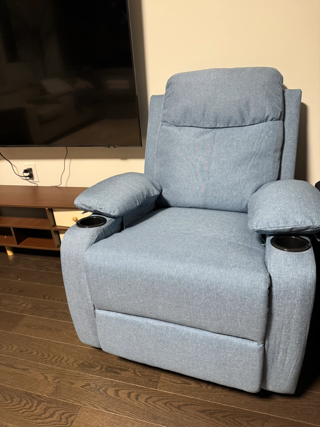 Blue upholstered recliner chair with cup holders