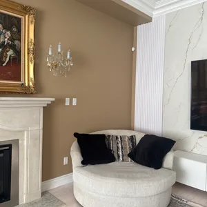 Round swivel accent chair with pillows