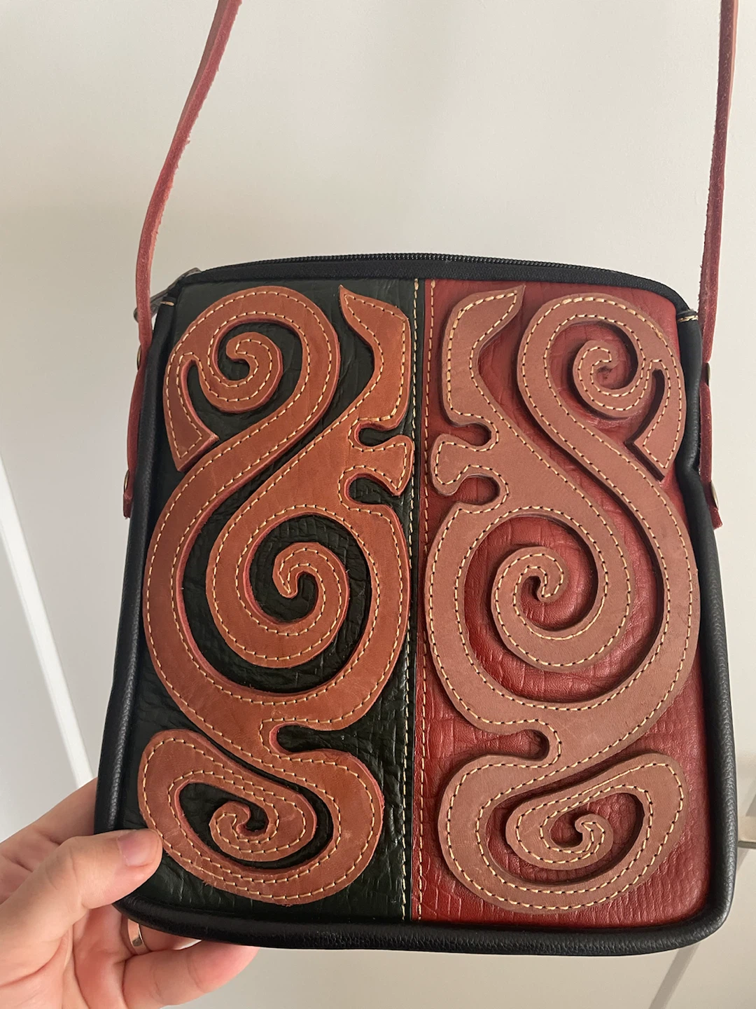 Black and Red Shoulder Bag with Decorative Appliqué