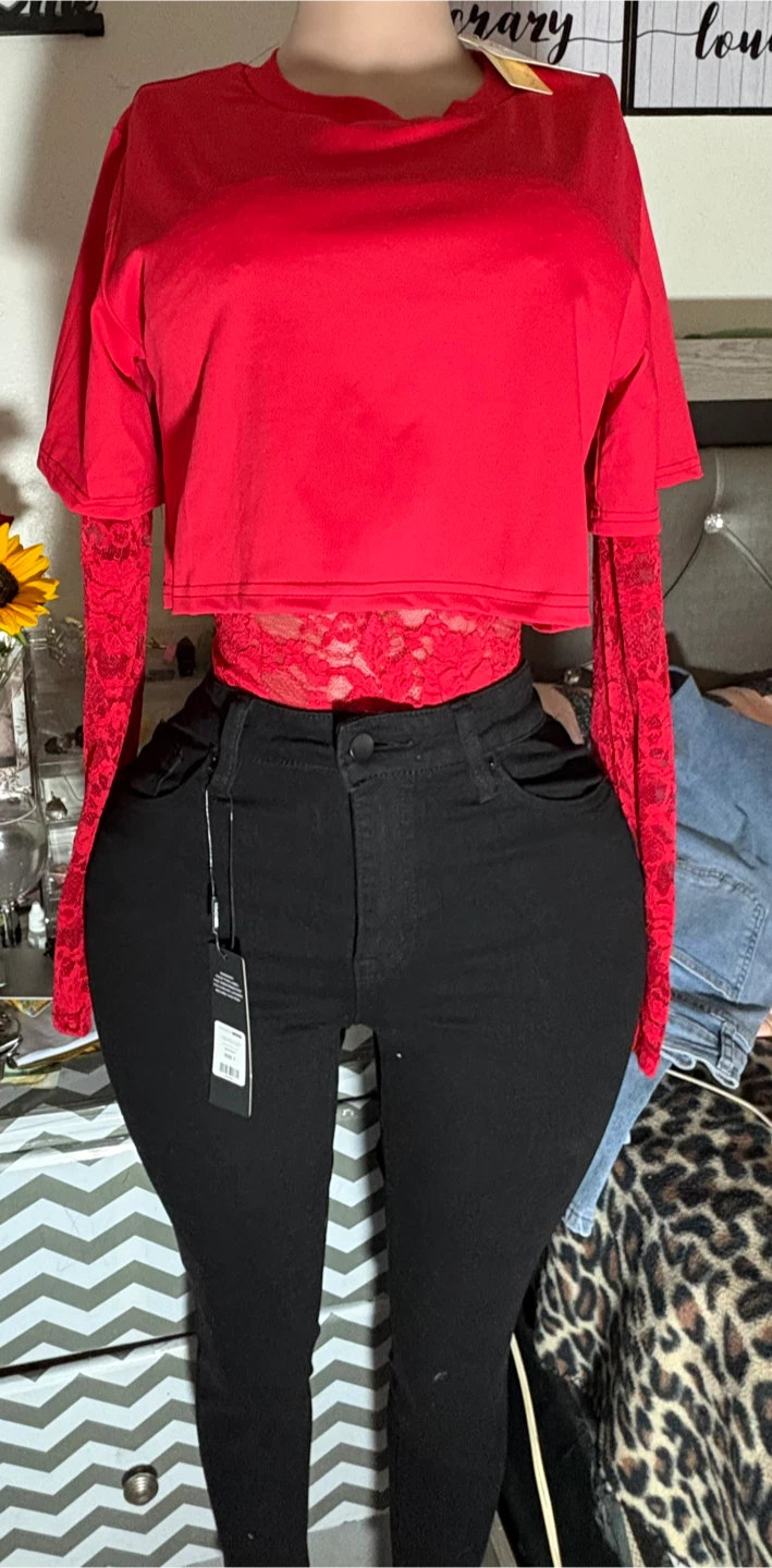 Red crop top with lace sleeves and black jeans
