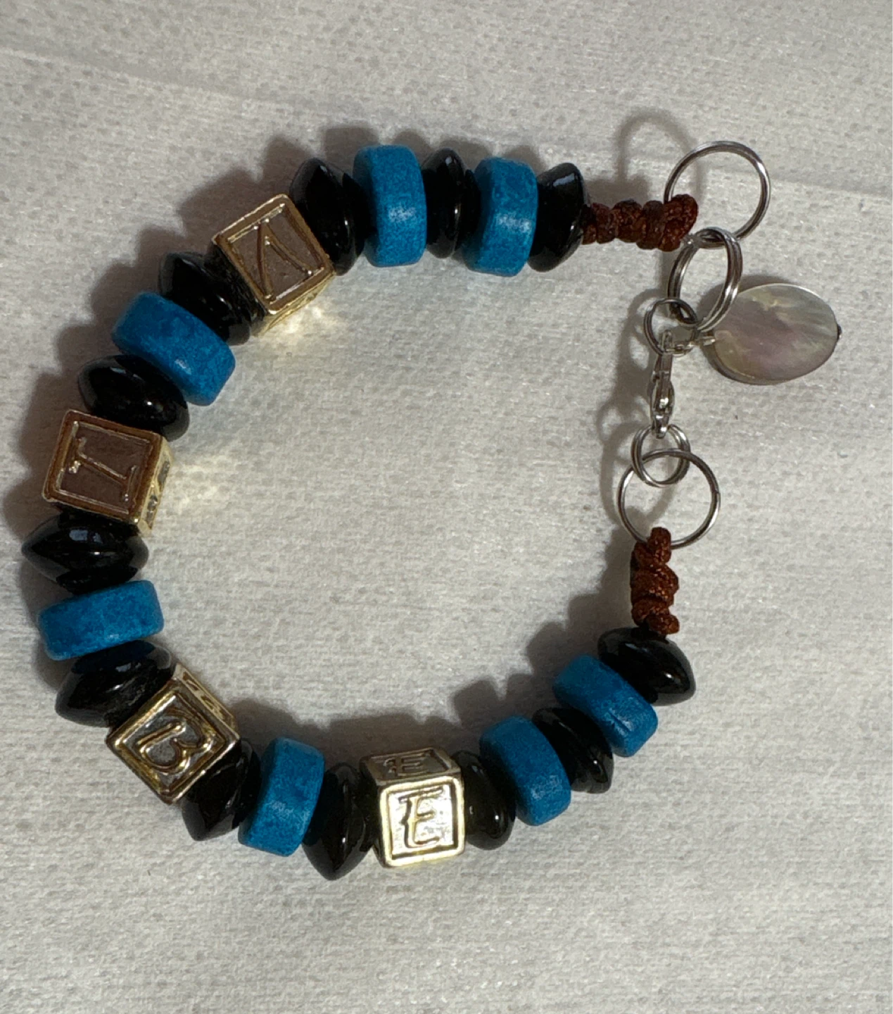Blue, Black, and GoldBeaded letters( VIBE) Bracelet