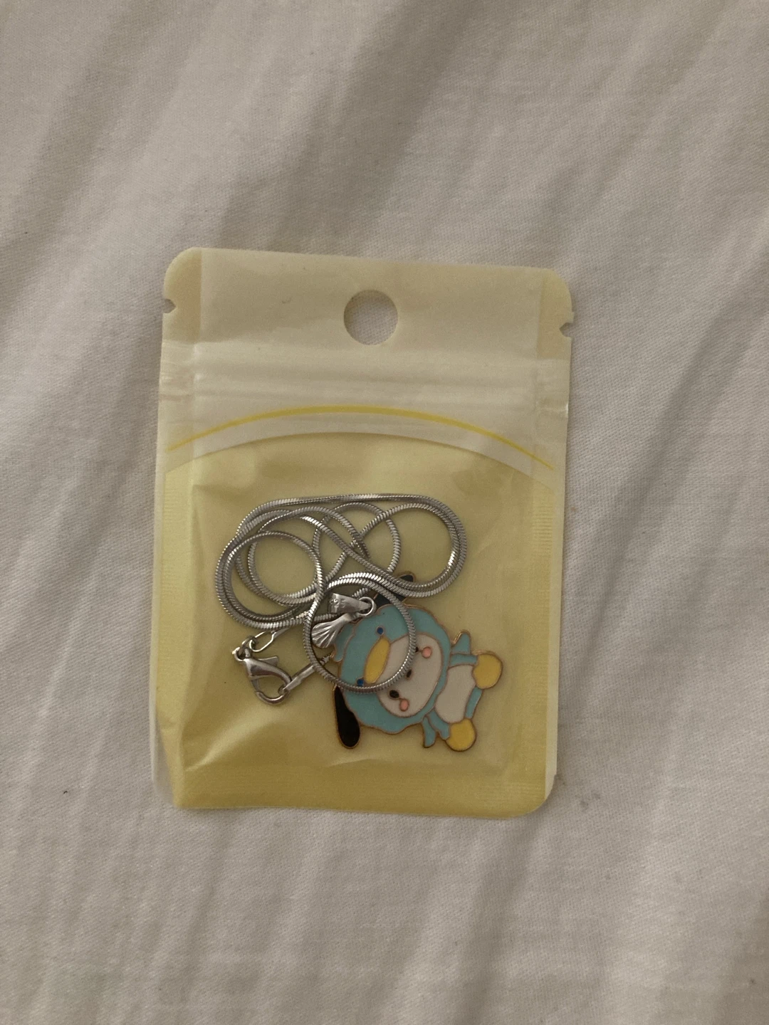 sealed sanrio pochacco necklace (doesn't tarnish)