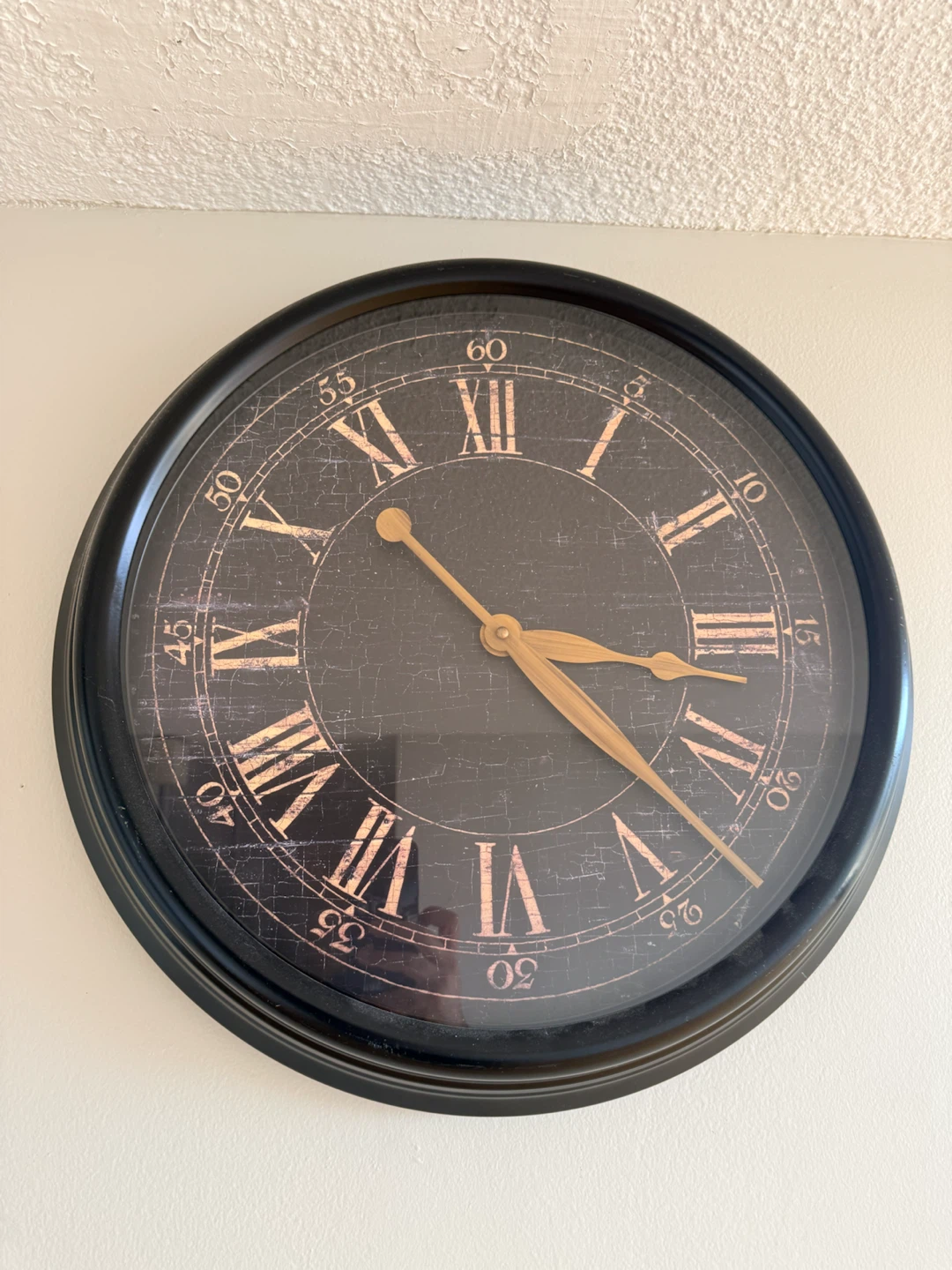 Black metal Roman Numeral Wall Clock