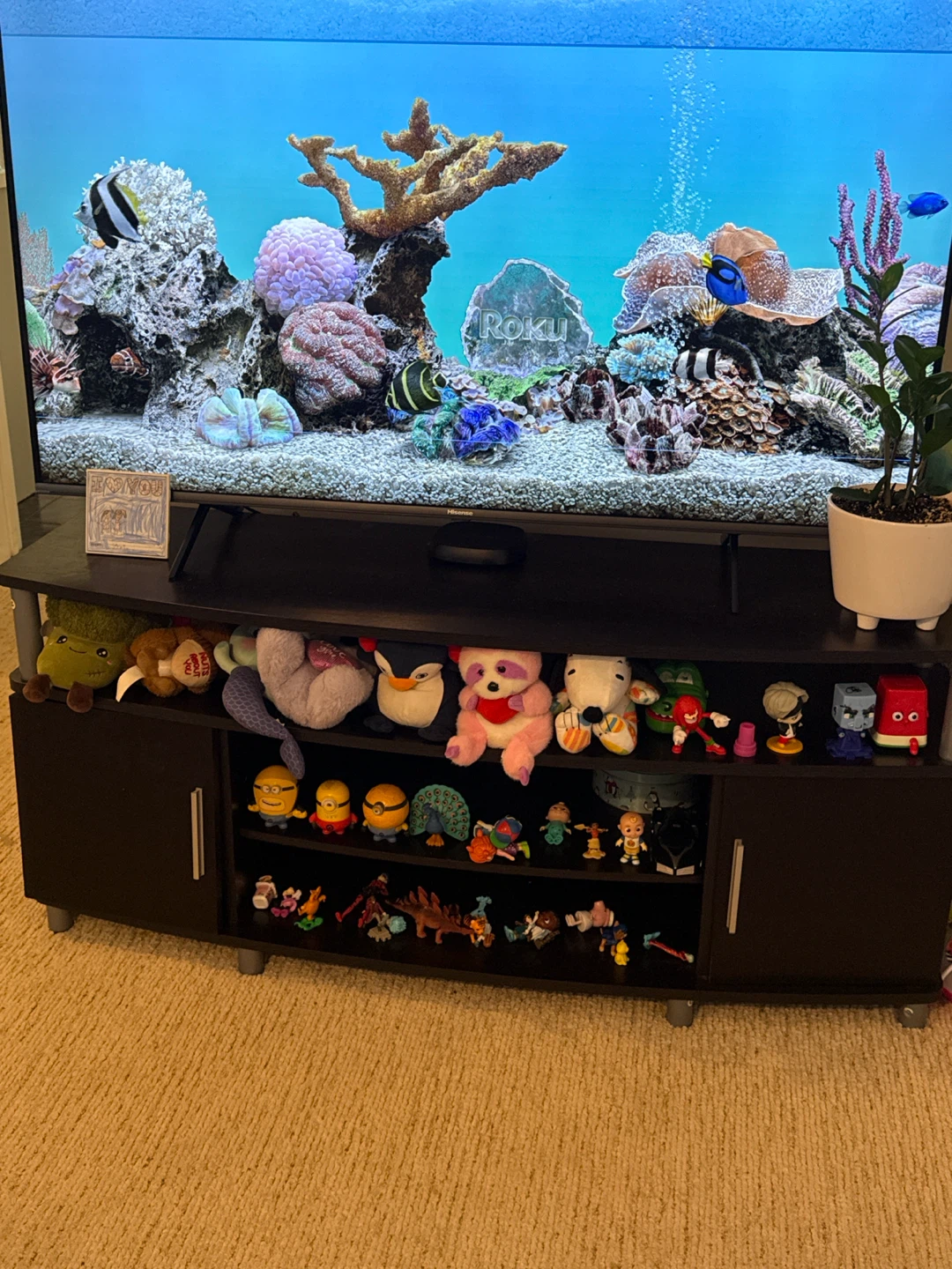 Black TV Stand with Many Collectible Figurines