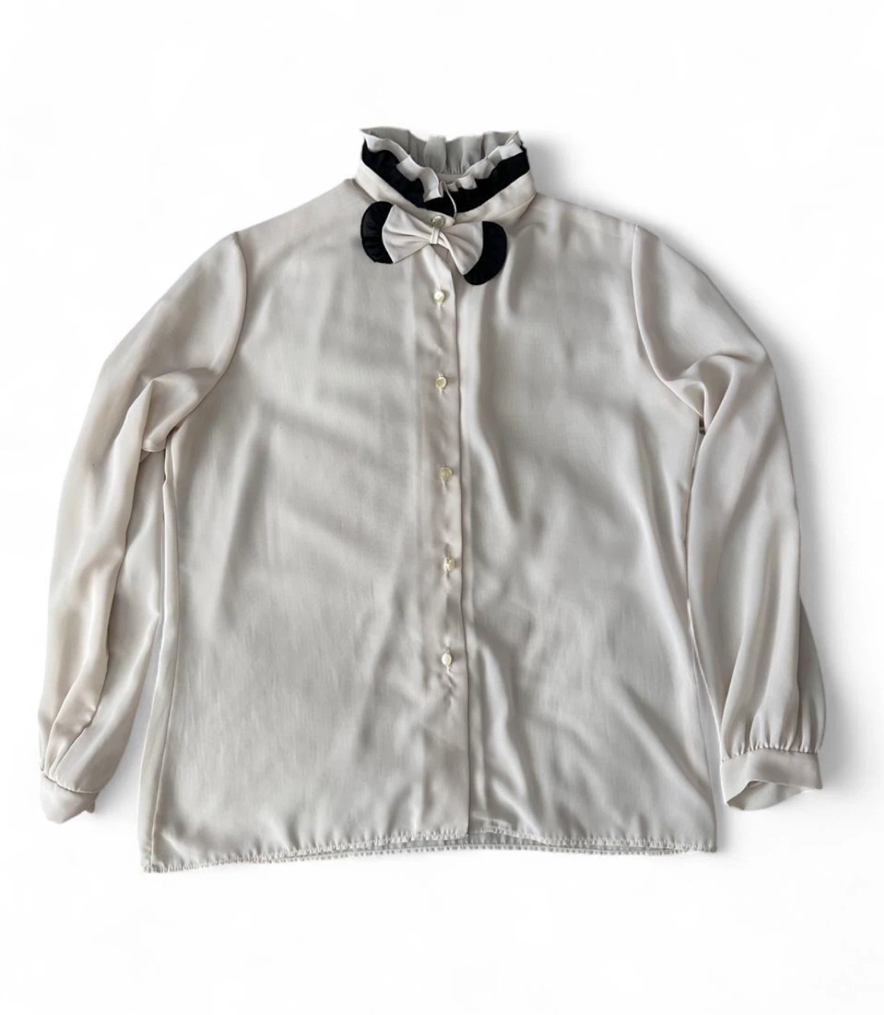 White blouse with black bow detail
