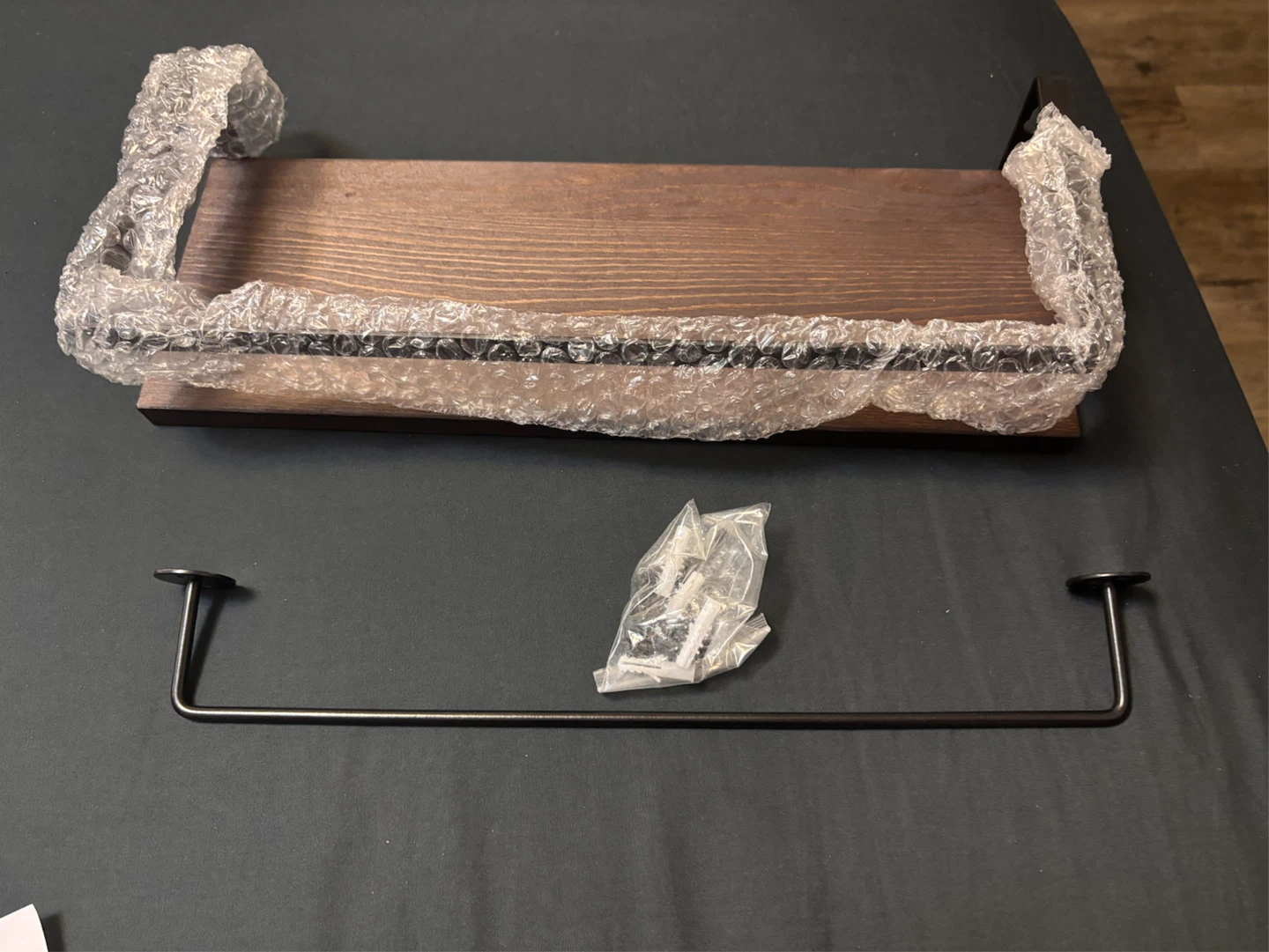 Wooden shelf with an additional metal towel bar