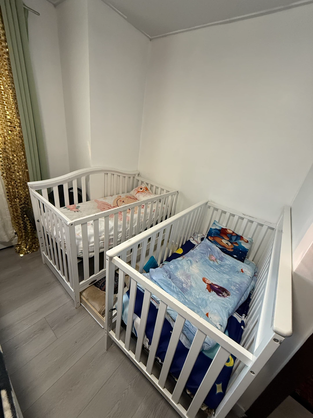 White wooden cribs with bedding