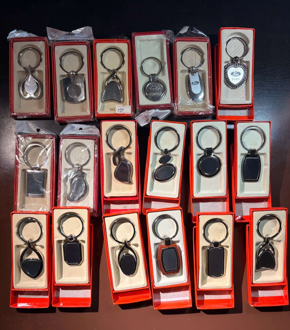 Lot of 18 new keychains with boxes. Price is for all 18 items.