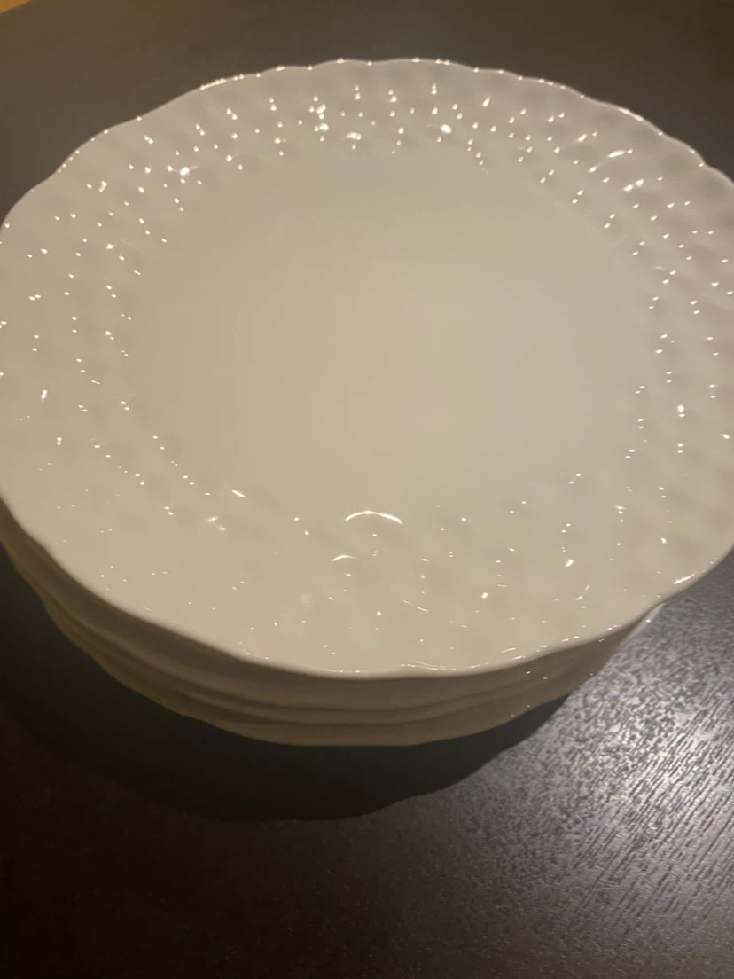 Set of white textured dinner and dessert plates