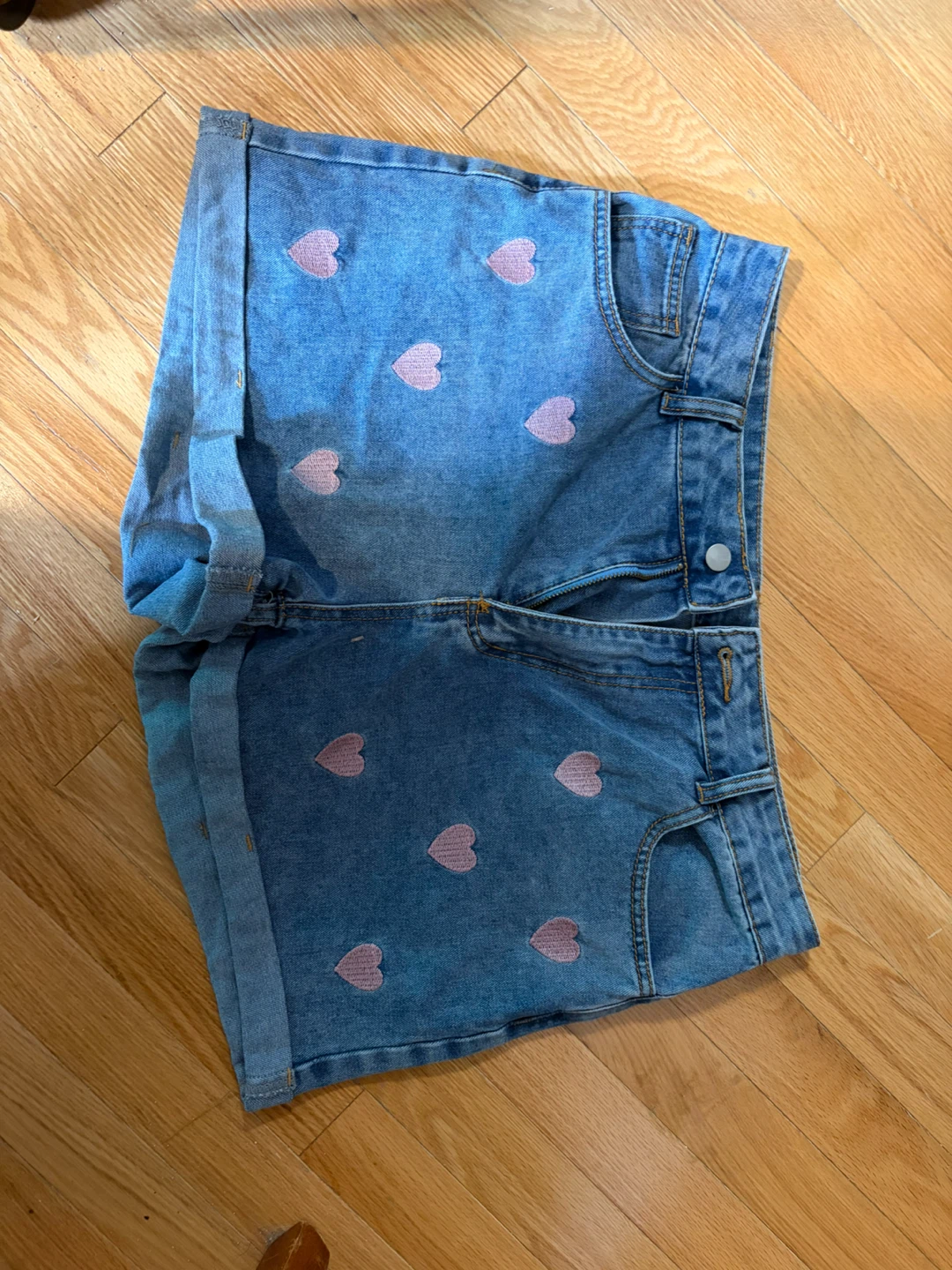 Denim shorts with pink hearts