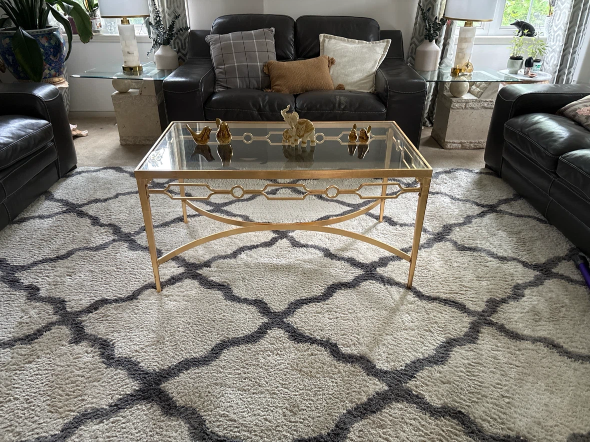 Elegant centre coffee table with gold finish and glass top.