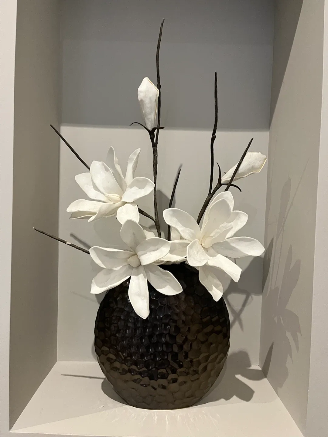 Hammered metal vase with artificial flowers
