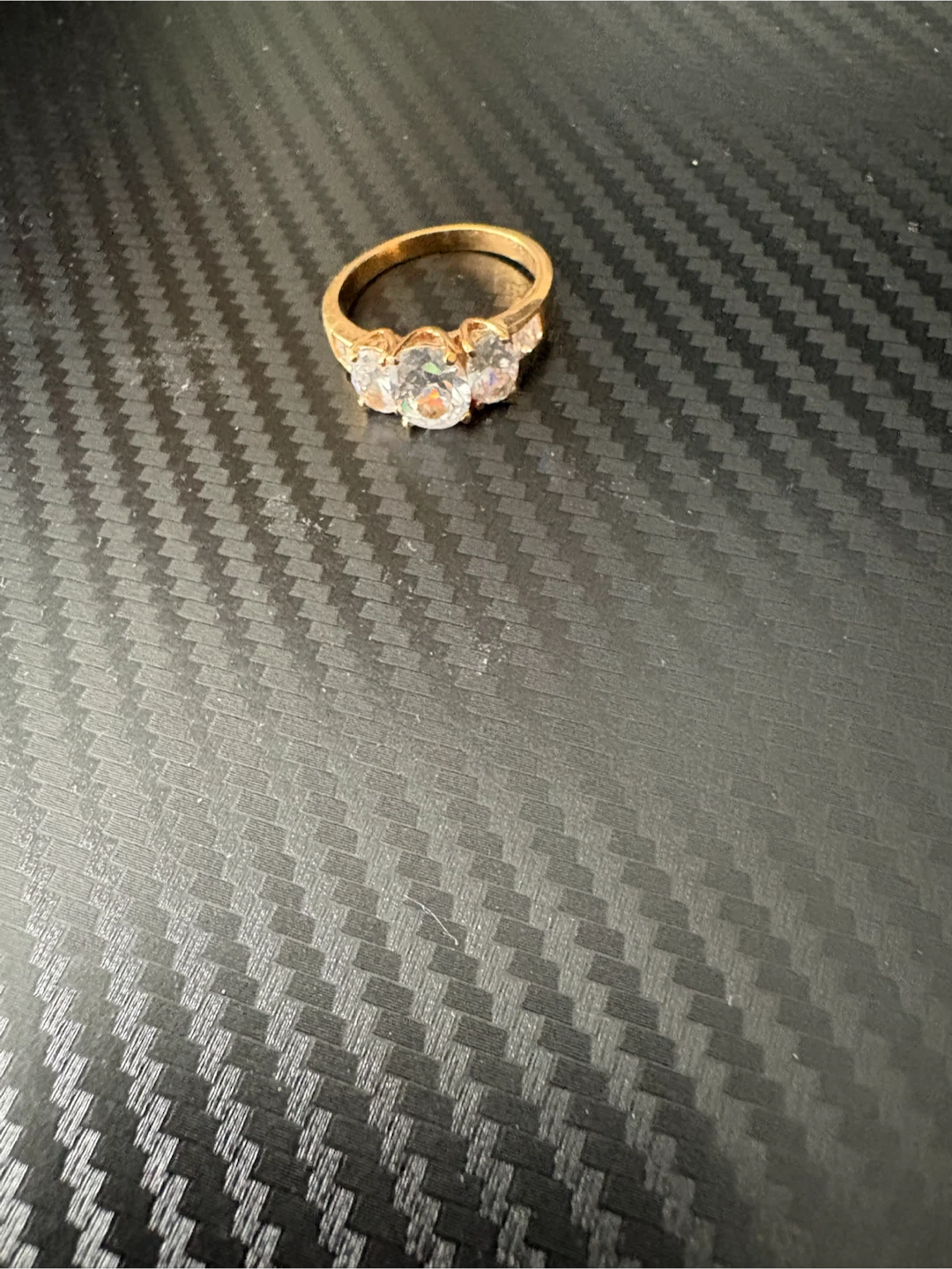 Gold-tone ring with three clear stones