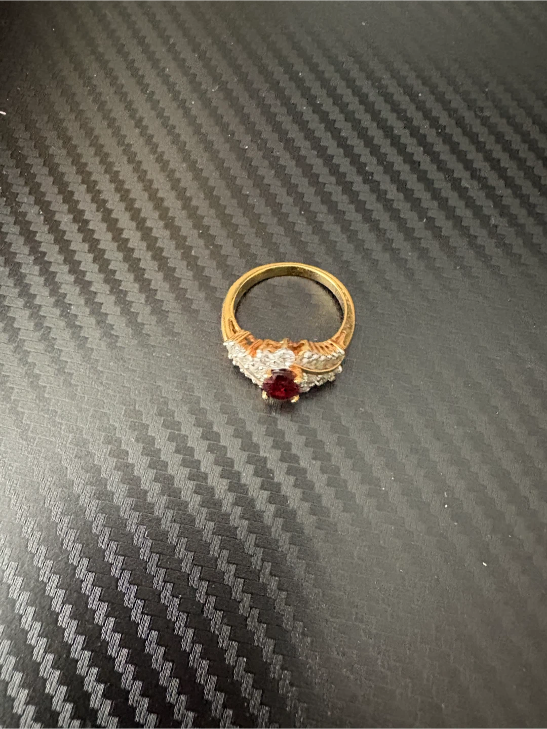 Gold tone ring with red stone and diamonds