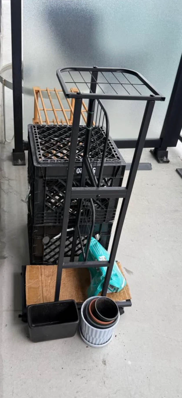 Black metal plant stand with pots