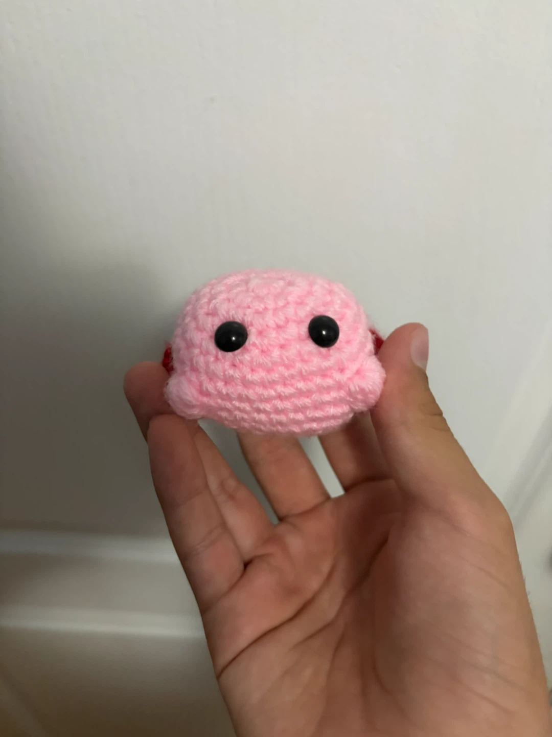 Hand-crocheted Kirby plushie