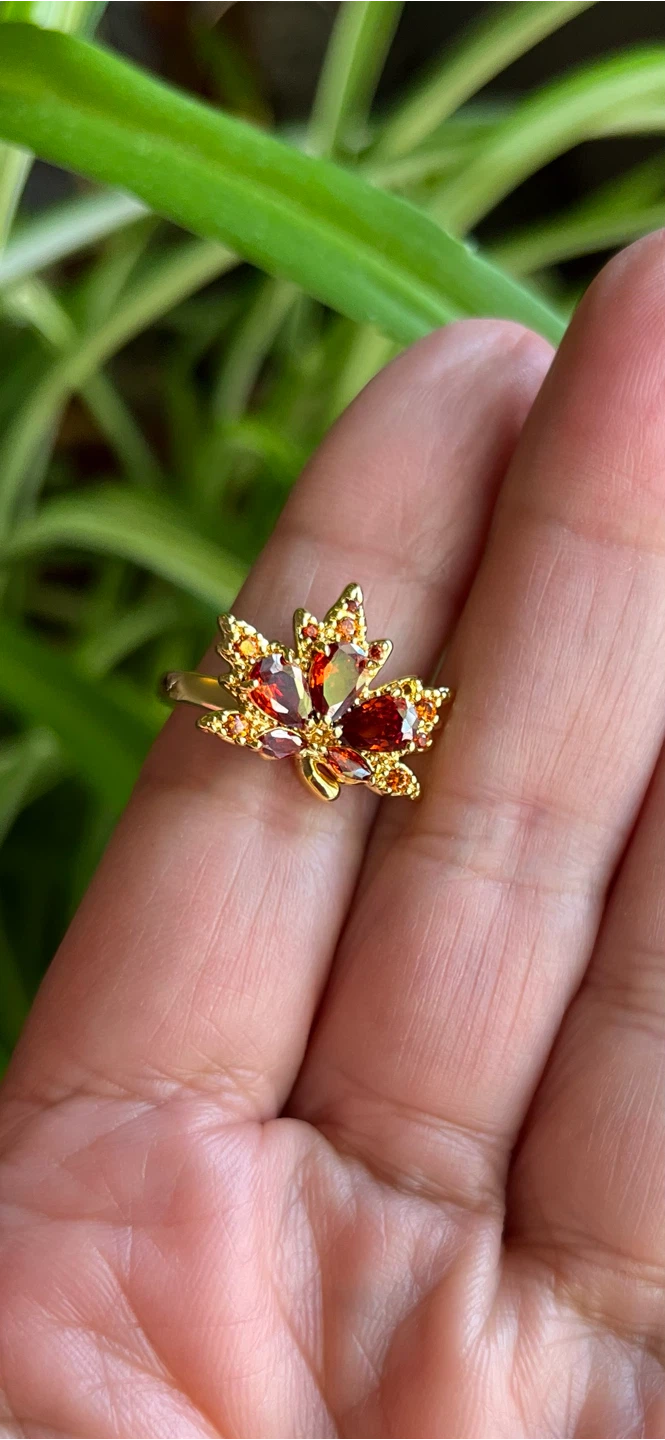 Gold-tone maple leaf ring with orange and red gems