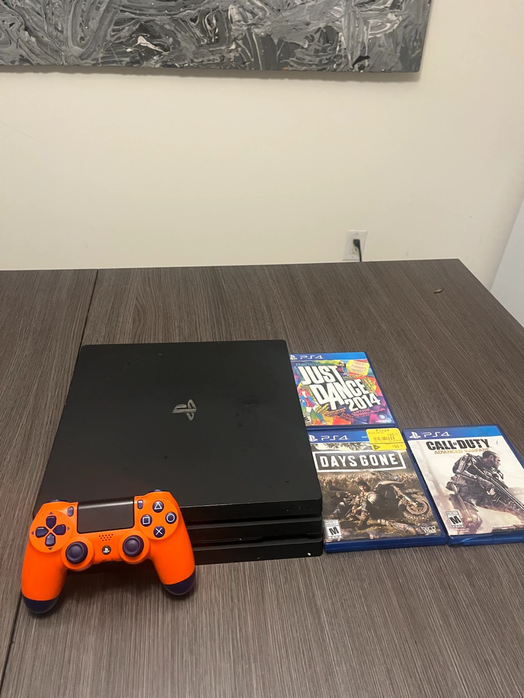 PlayStation 4 Pro Console with Orange Controller and Games