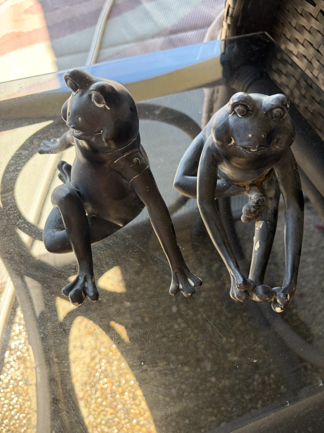 Pair of dark metal frog figurines