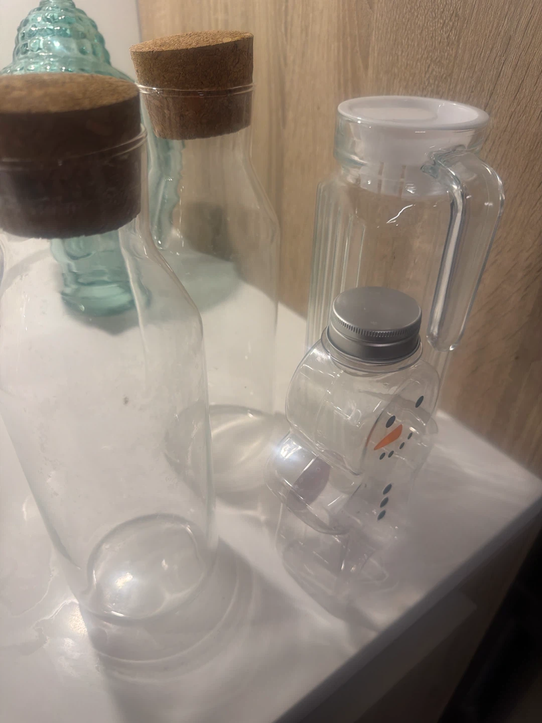 Glass bottles and snowman-shaped container