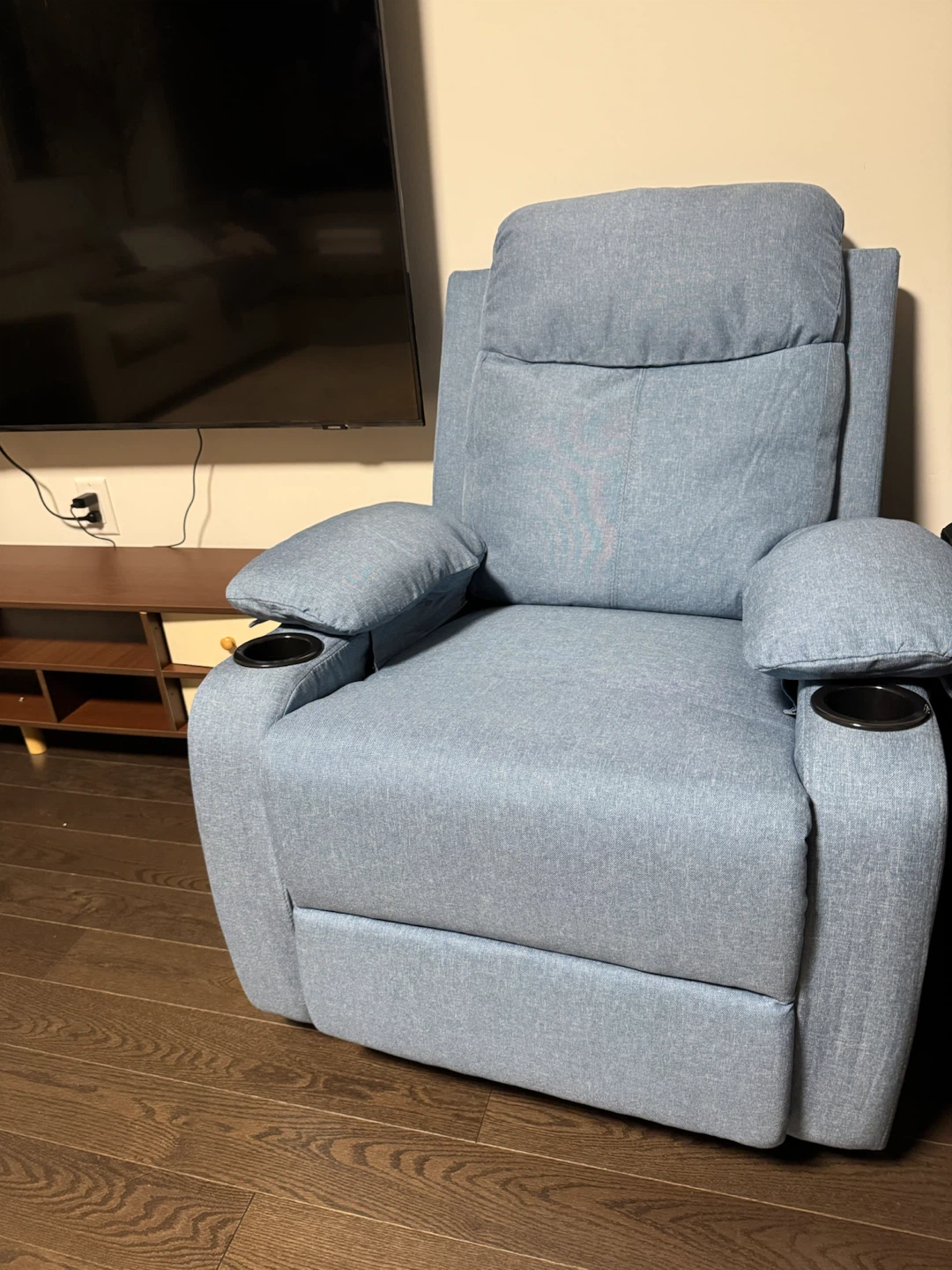 Blue upholstered recliner chair with cup holders
