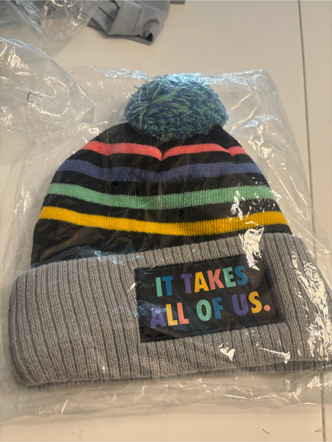 Striped Beanie with "It Takes All Of Us" Patch