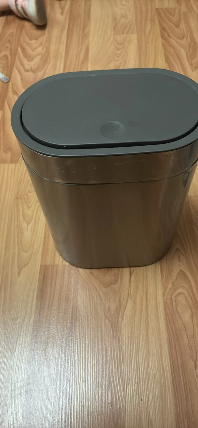 Small garbage can with click and pop lid.