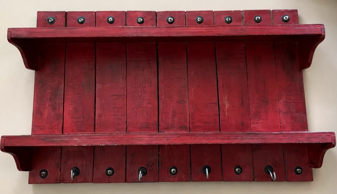 Red wooden shelf with hooks