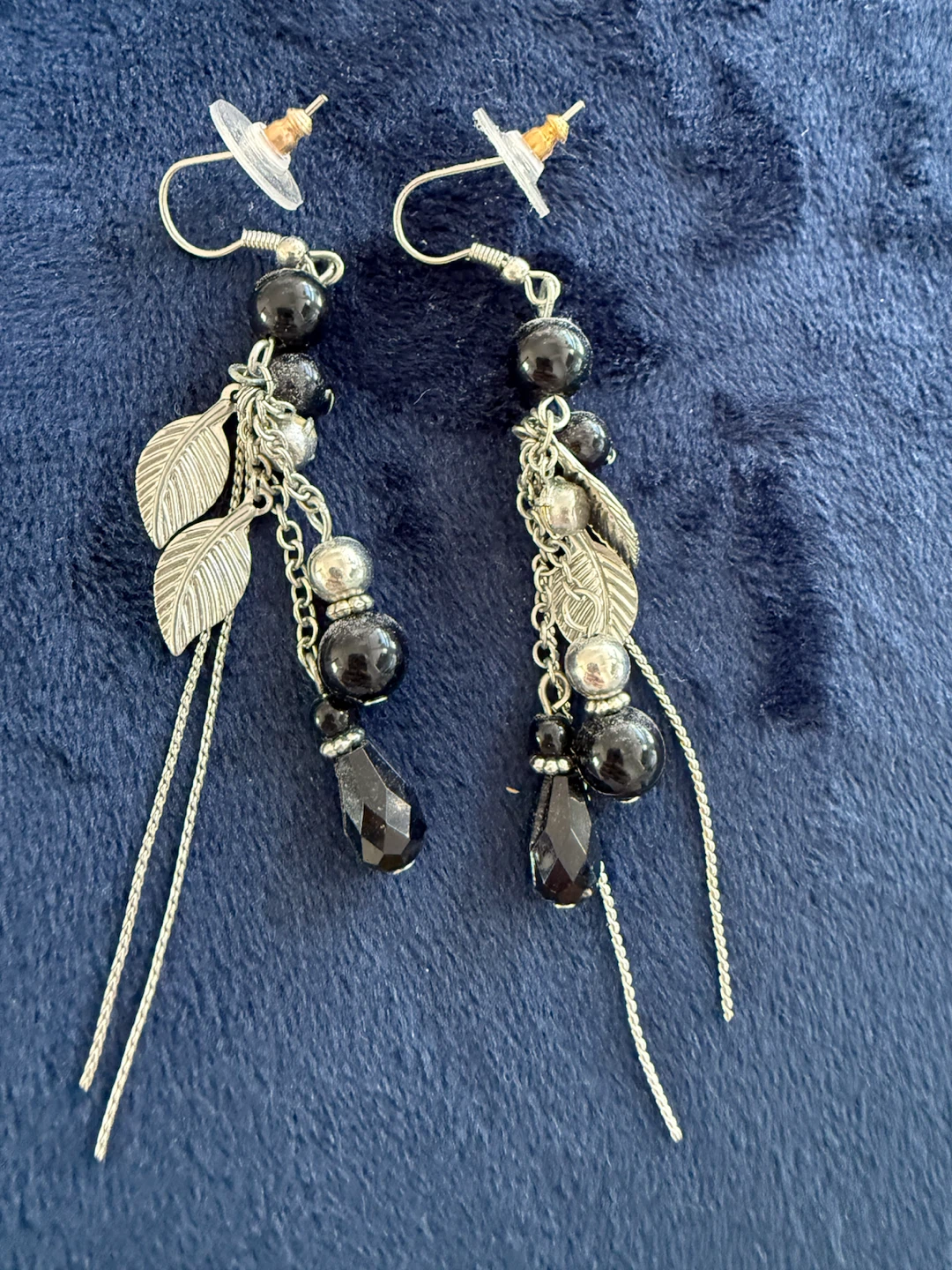 Black beaded dangle earrings with feather charms