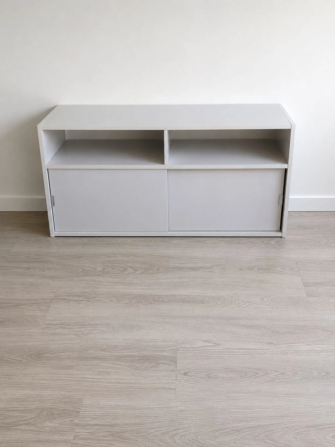 Grey media console with sliding doors