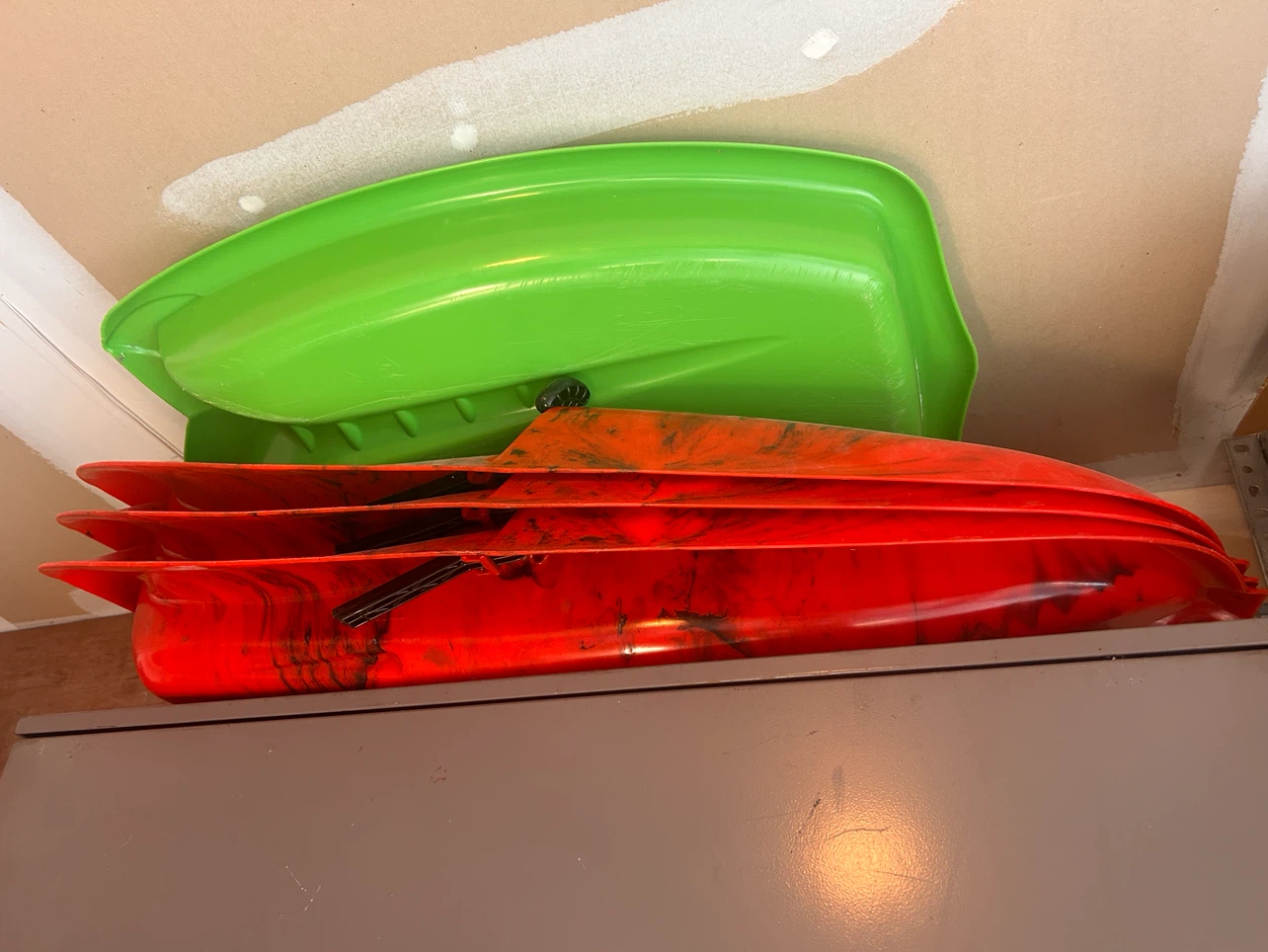 Green and Red Toboggan Sleds