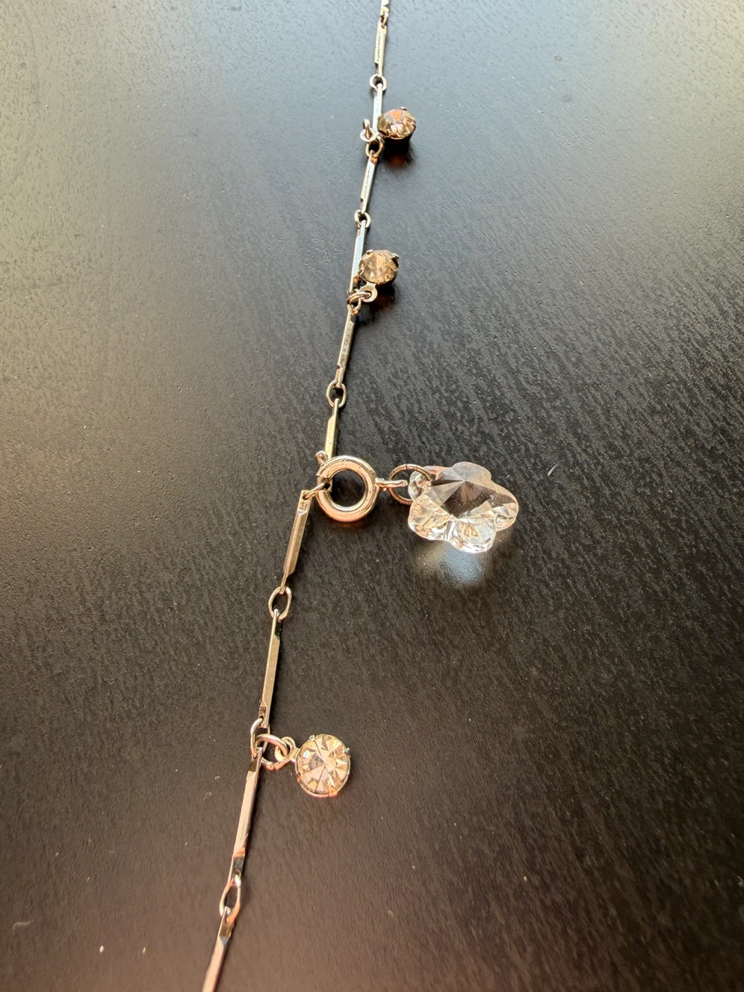 Silver tone ankle bracelet with clear crystal flower