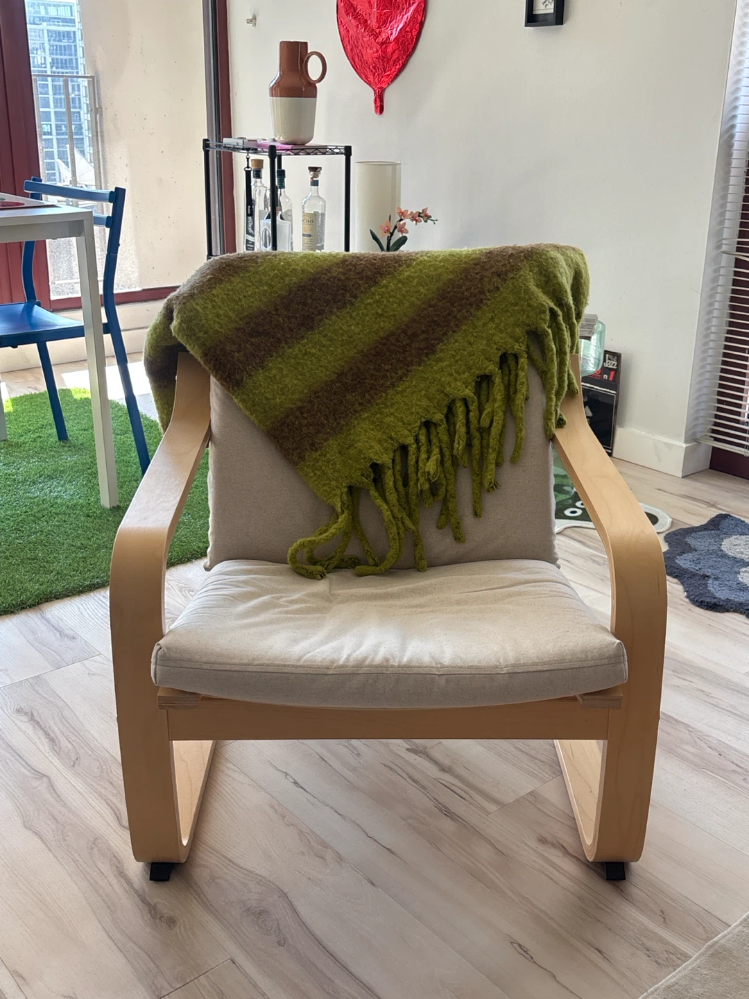 Modern Lounge Chair with Green Striped Throw Blanket