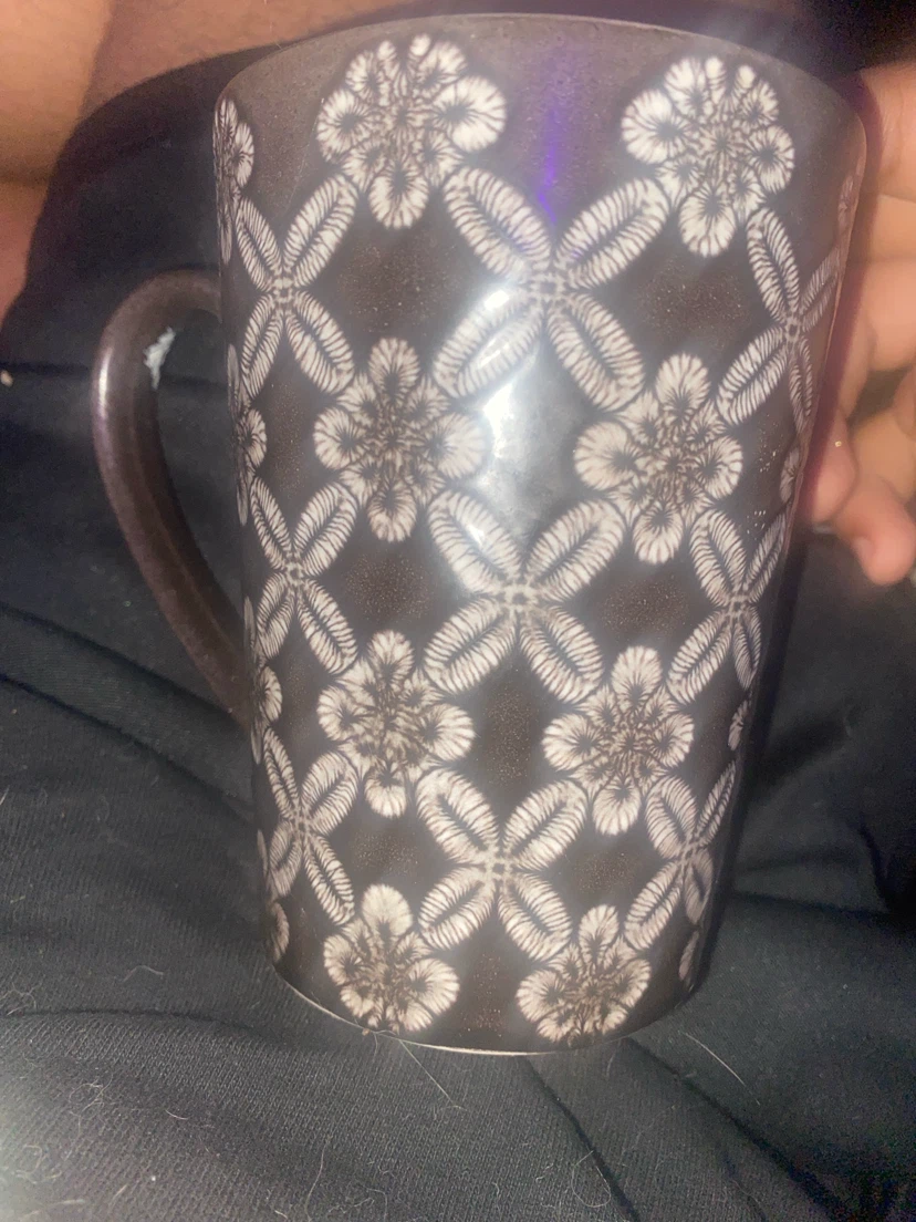 Brown mug with white floral pattern