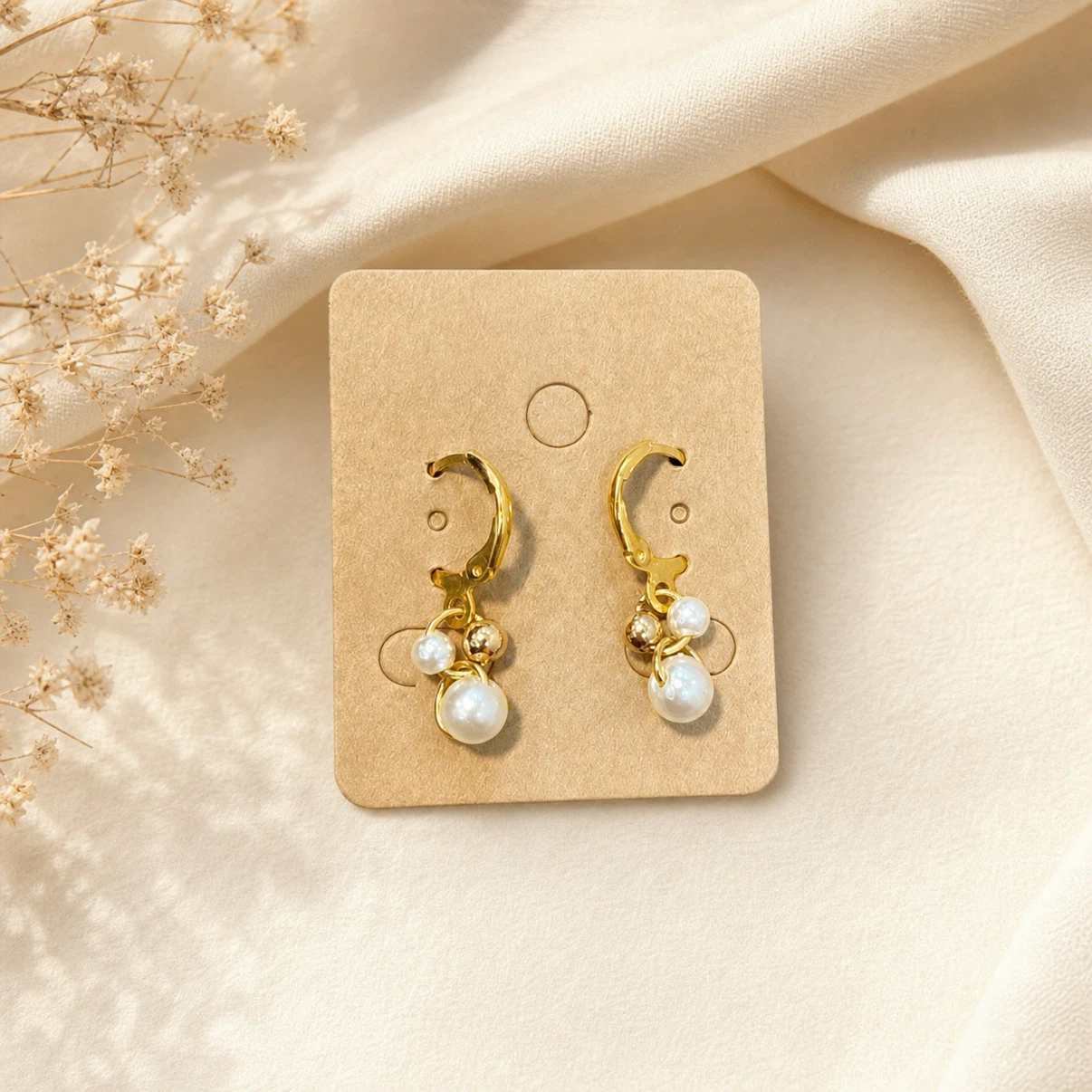 Gold-tone earrings with pearl and bead accents