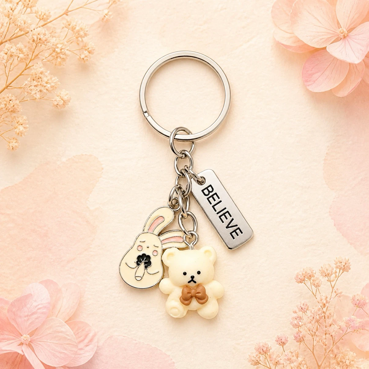 Keychain with Bear and Bunny charms and "BELIEVE" tag