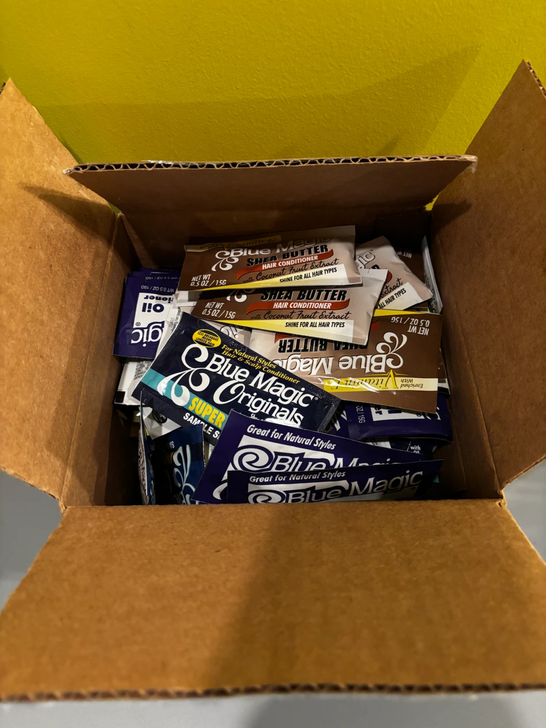 A box of Blue Magic Hair Sample Packets
