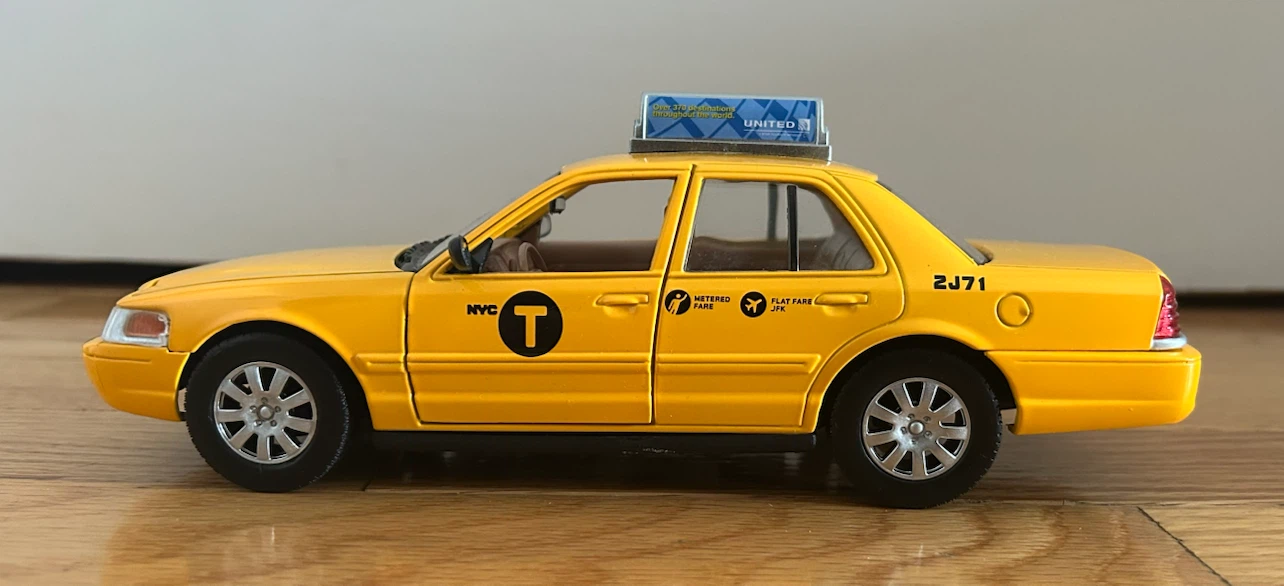Yellow Ford Crown Victoria Taxi Toy Car