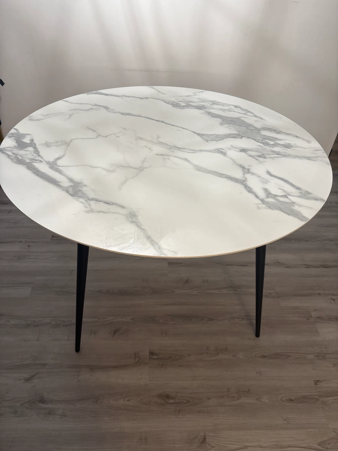 Marble top round dining table with black legs