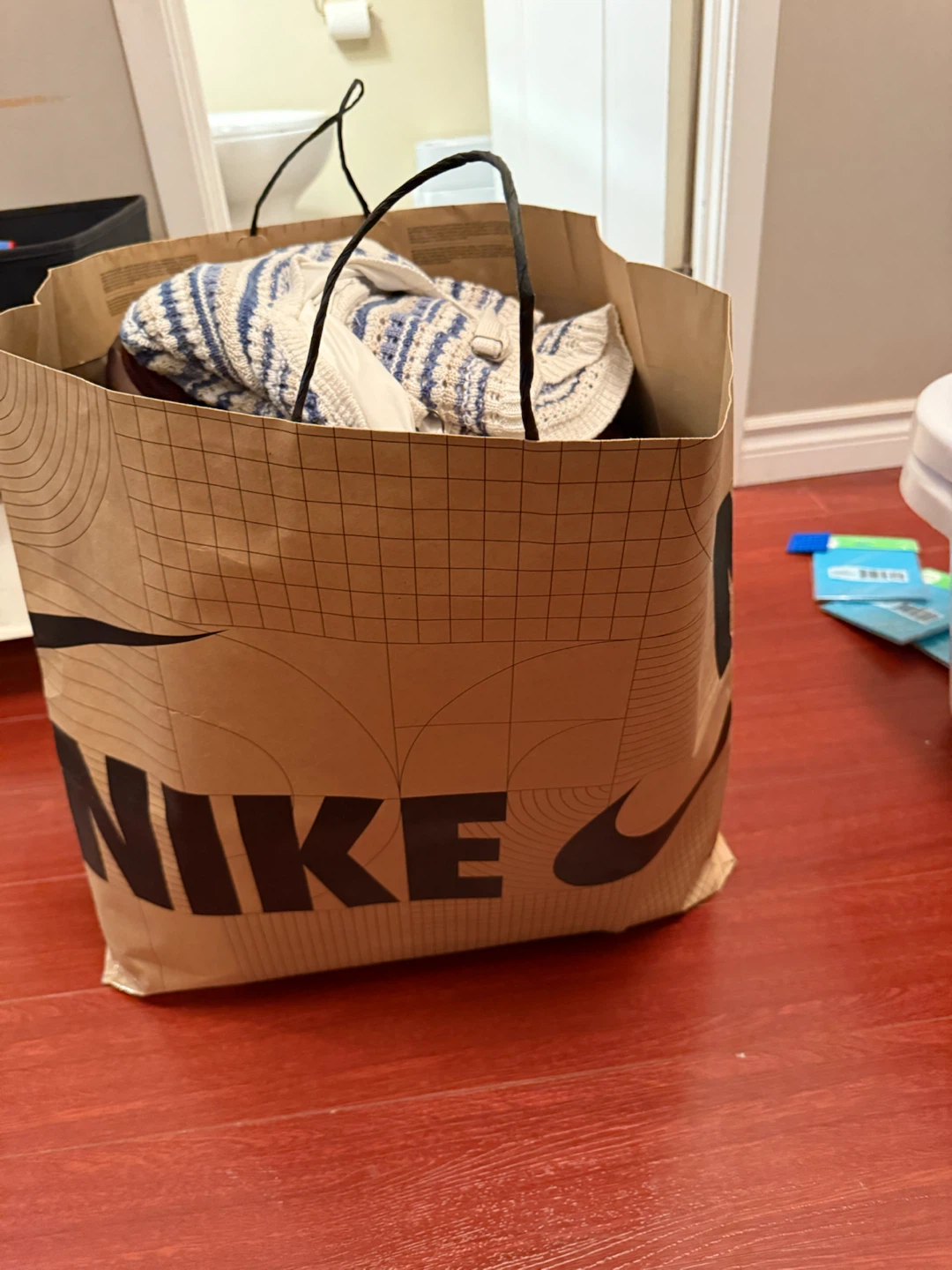 NIKE Shopping Bag with Assorted Clothing Items - photo 2