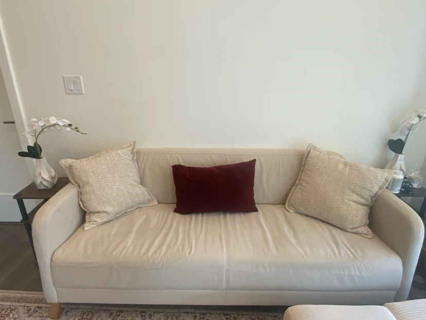 Cream coloured sofa with decorative pillows